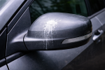 Car-Mirror DP A Car side view mirror with dried paintball residue